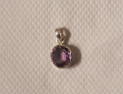 Purple gemstone in a silver lavaliere