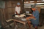 Aquilles Caranza and his grandson preparing all the bread manually